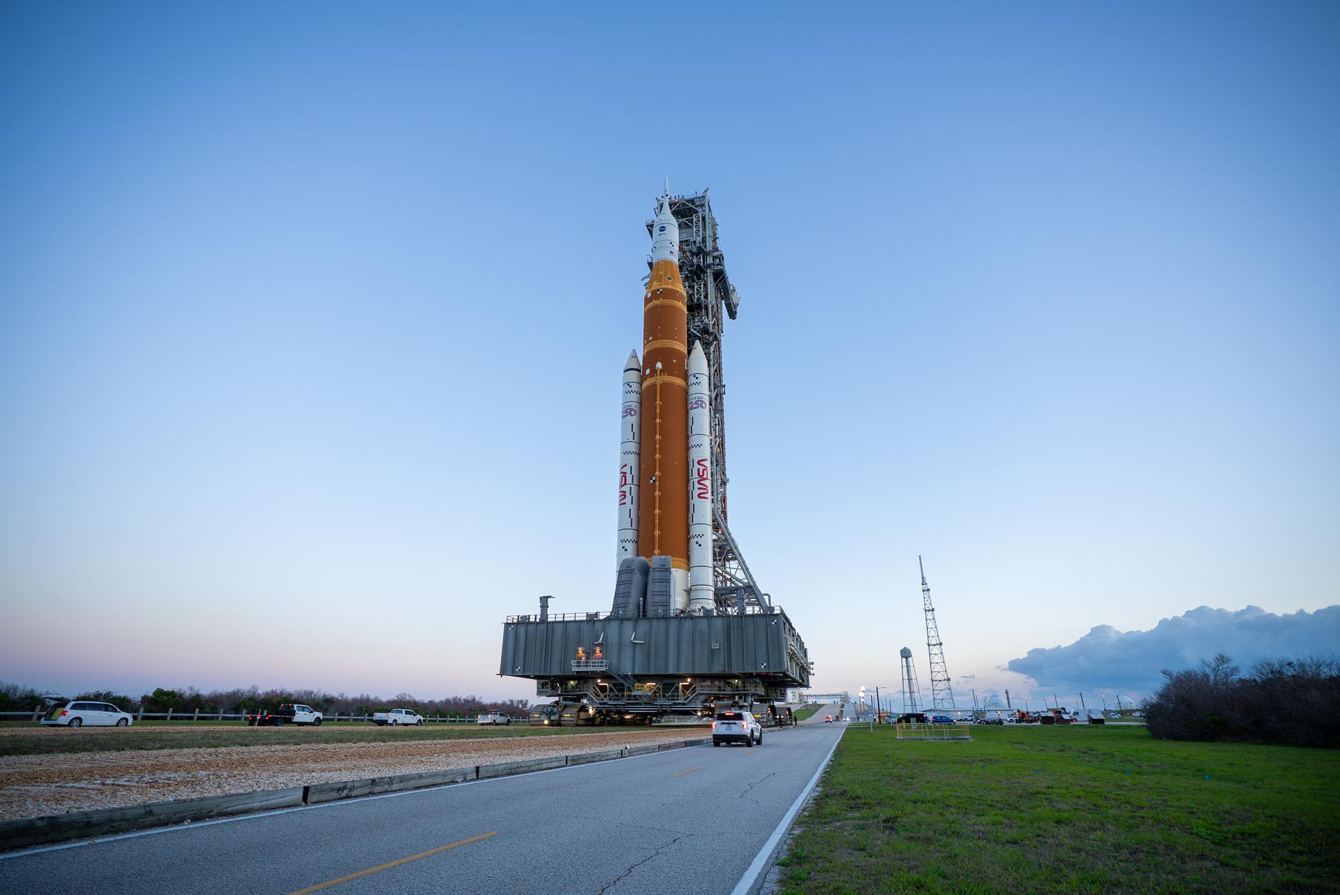 This image shows NASA’s SLS (Space Launch System) and Orion spacecraft rolling out of the Vehicle Assembly Building at NASA’s Kennedy Space Center. NASA's massive Crawler-Transporter, upgraded for the Artemis program, carries the powerful SLS rocket and Orion spacecraft on the Mobile Launcher from the Vehicle Assembly Building to Launch Pad 39B at Kennedy Space Center in preparation for the Artemis II mission. 